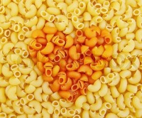 Texture units of the yellow and orange pasta with the image of the heart in the middle, stock photo | ColourBox